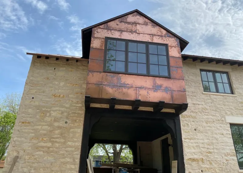 Copper metal panel facade on a stone building for Roof Repair in Tolleson